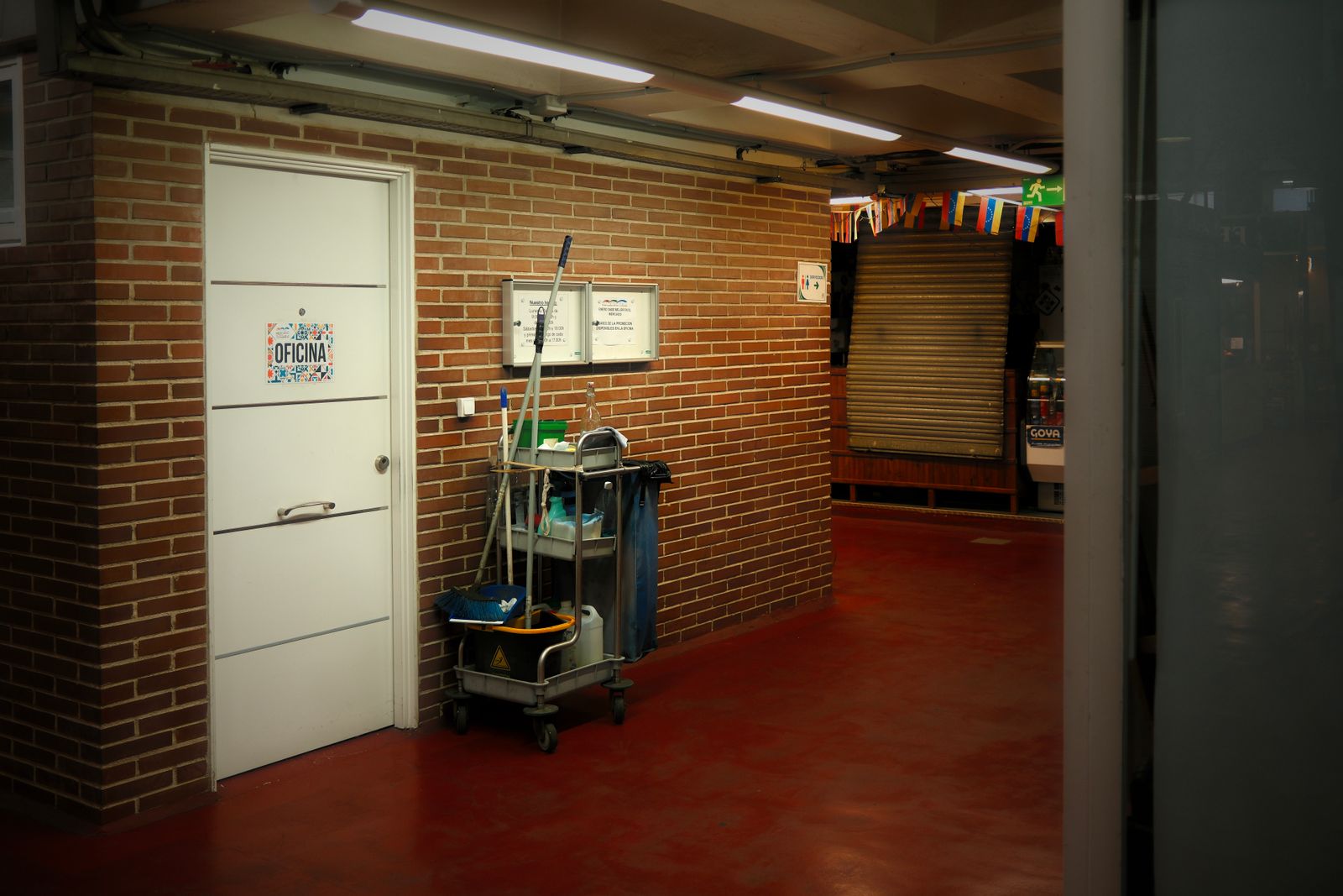 Industrial hallway with cleaning cart and maintenance supplies
