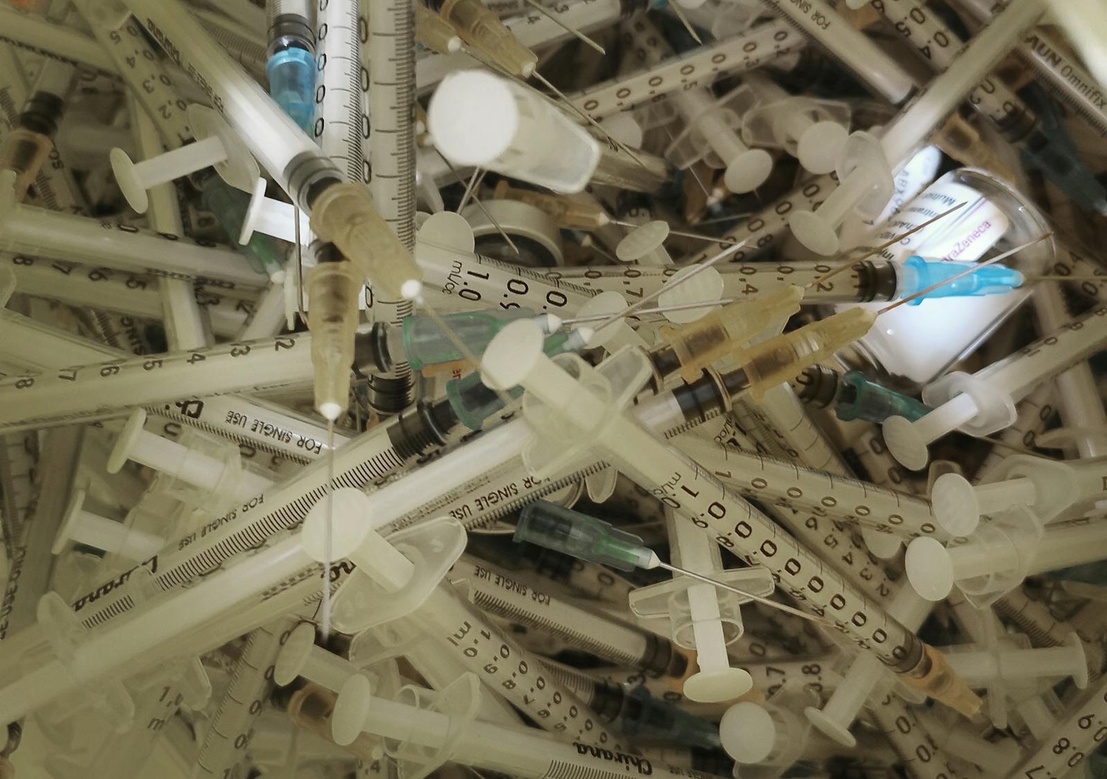 Close-up of syringes and medical sharps for safe disposal