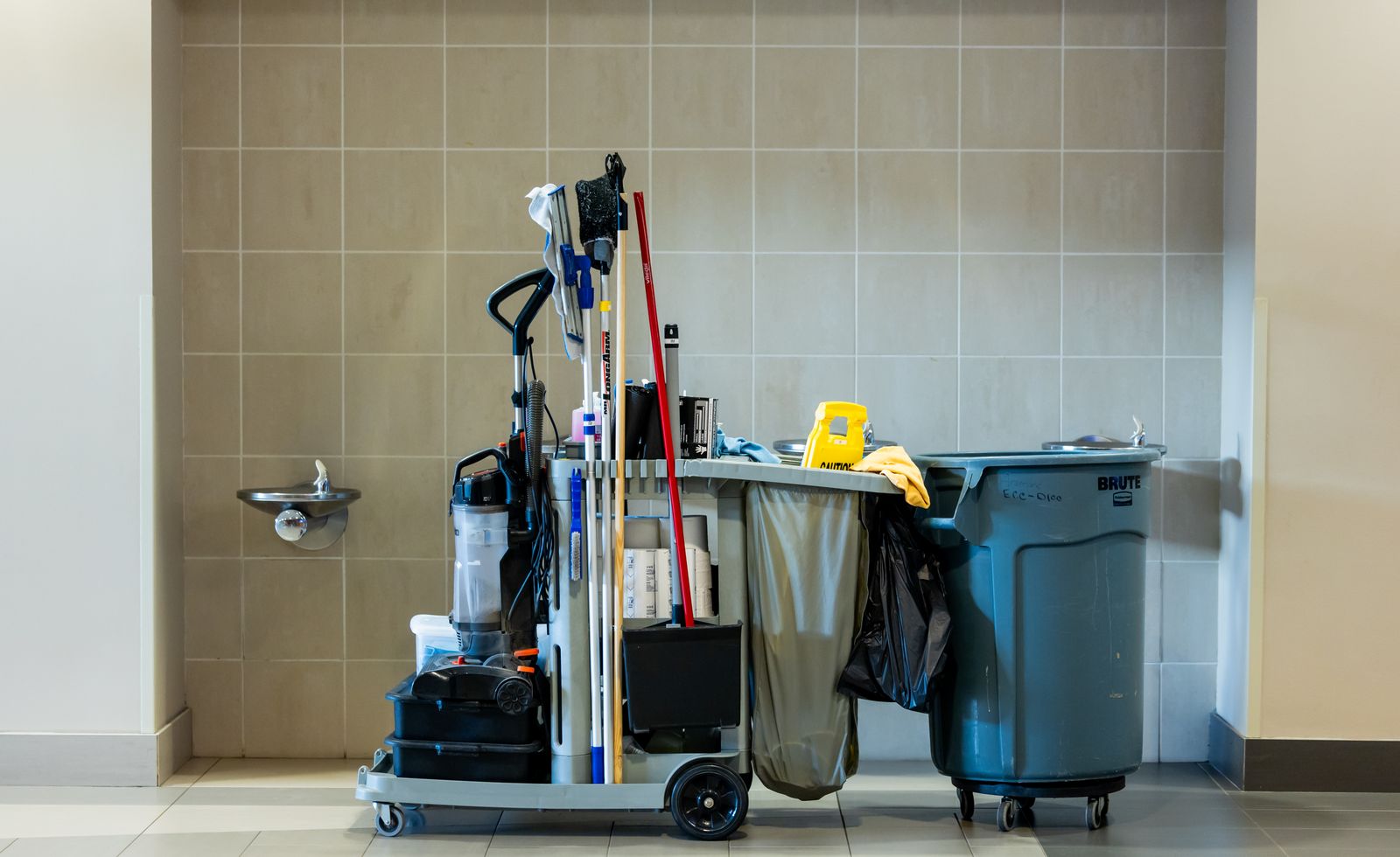 Professional cleaning cart with supplies in an office corridor
