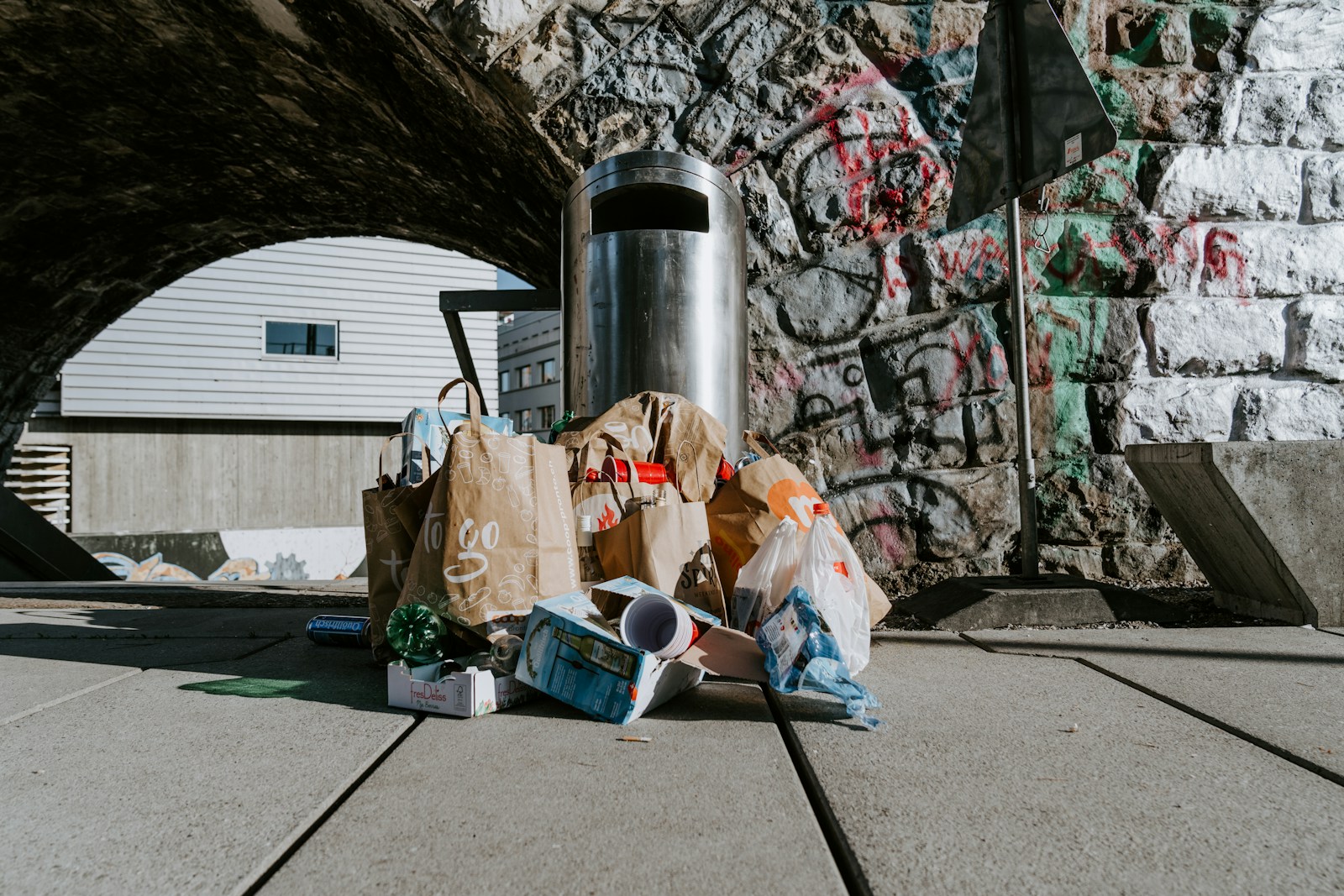 Rubbish bags collected beside outdoor bins before clearance