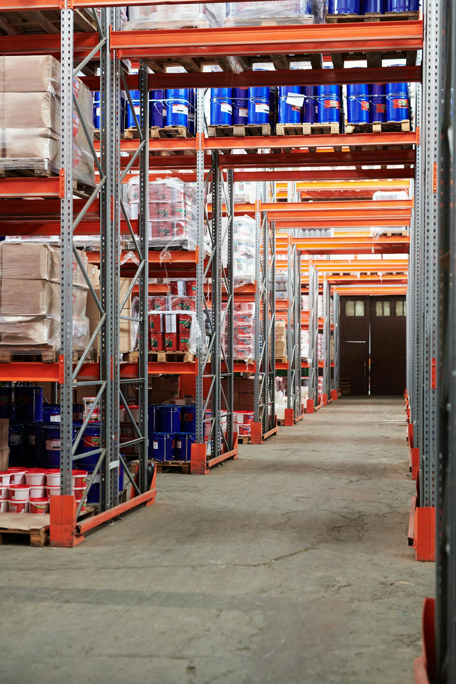 Clean warehouse aisle with concrete floor and organised shelving
